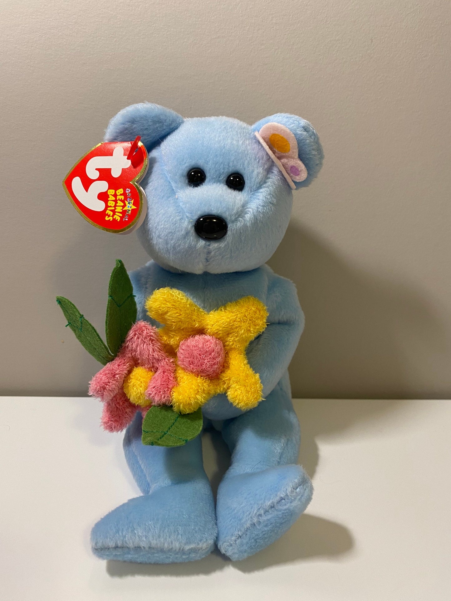 Ty Beanie Baby “Bluebonnet” the Blue Bear Holding Flowers (8.5 inch)