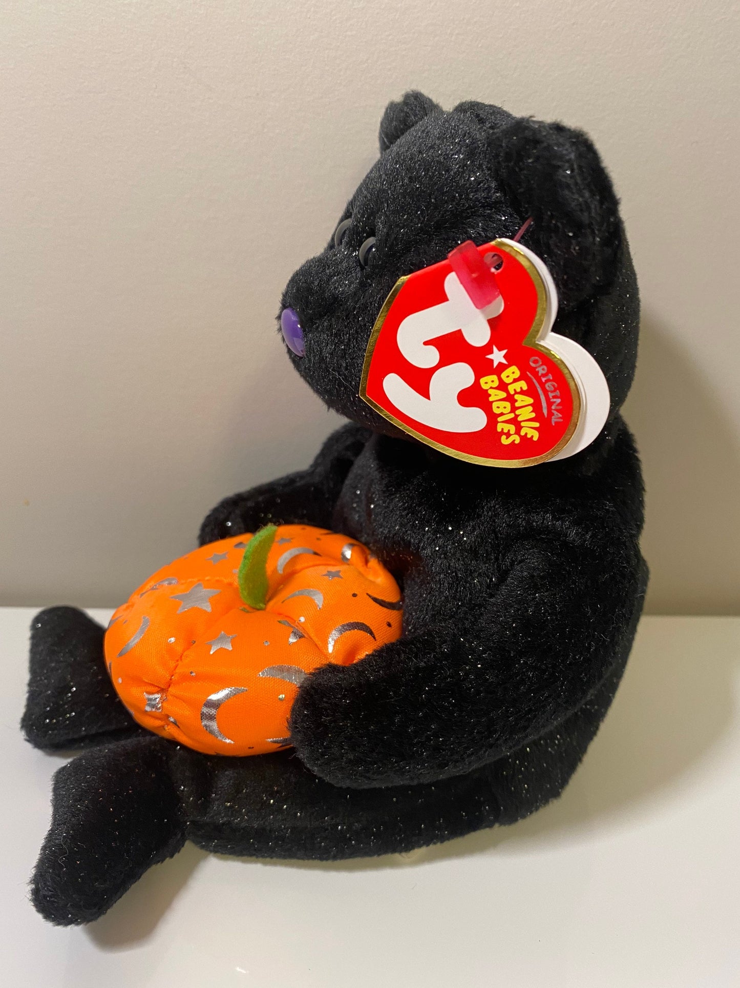 Ty Beanie Baby “Haunting” the Black Halloween Bear Holding a Pumpkin (8.5 inch)