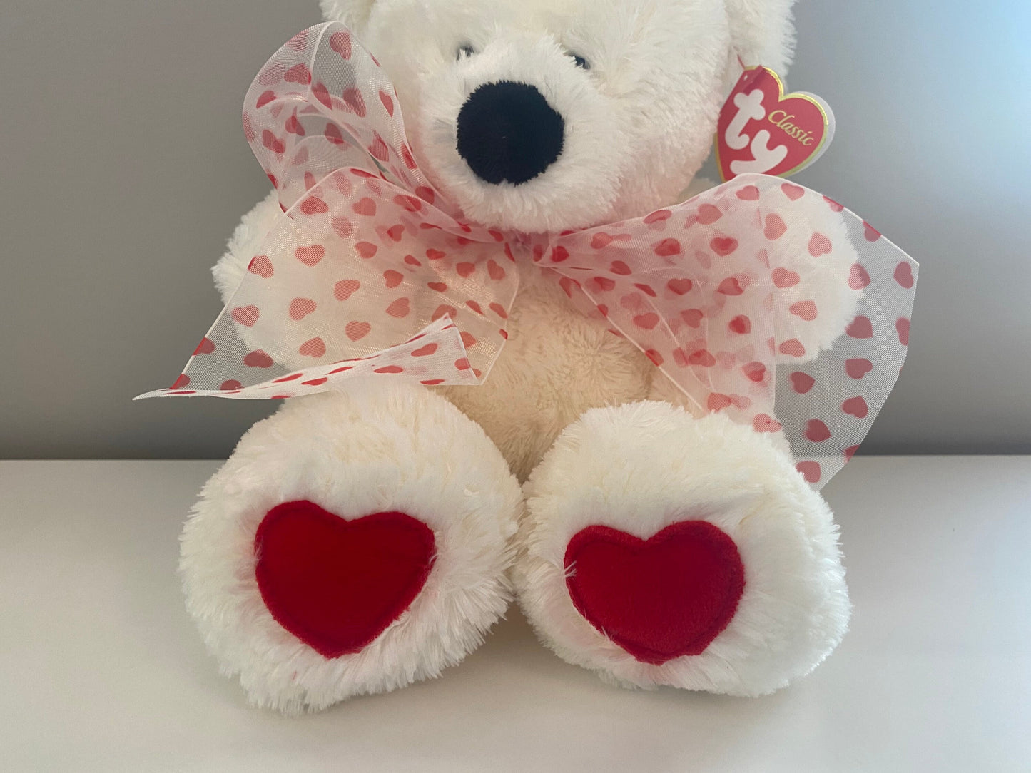 Ty Classics Collection “Caressa” the Bear  with Hearts on Feet and  Ribbon Bow around Neck (11 inch)