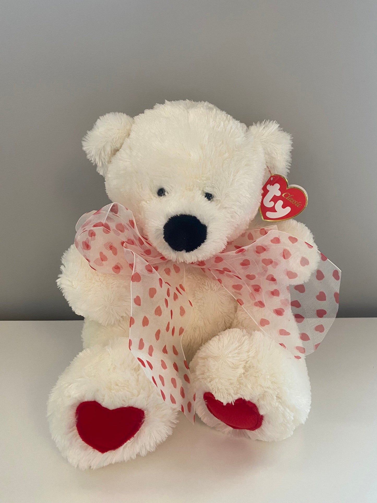 Ty Classics Collection “Caressa” the Bear  with Hearts on Feet and  Ribbon Bow around Neck (11 inch)